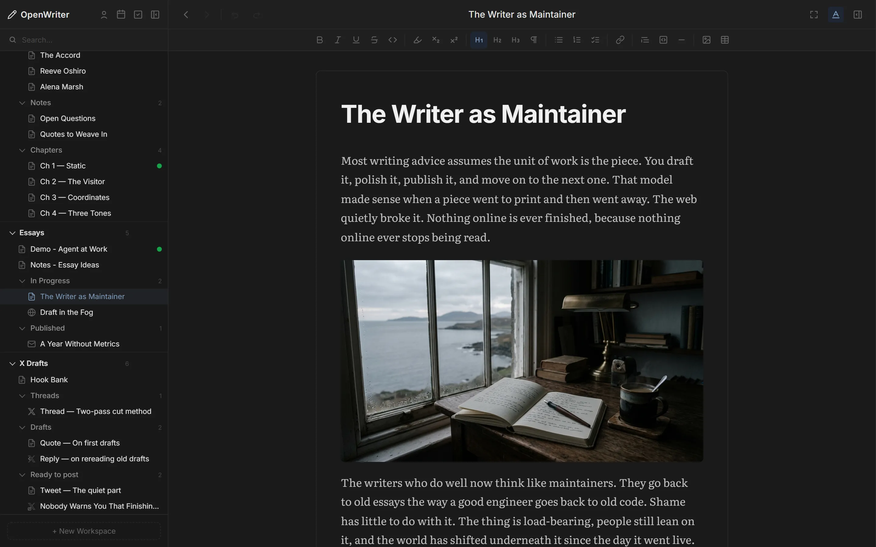 An essay in OpenWriter with formatted paragraphs and an inline image of a writing desk